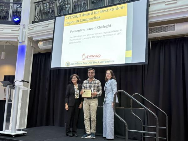 Saeed Khaleghi posing with award